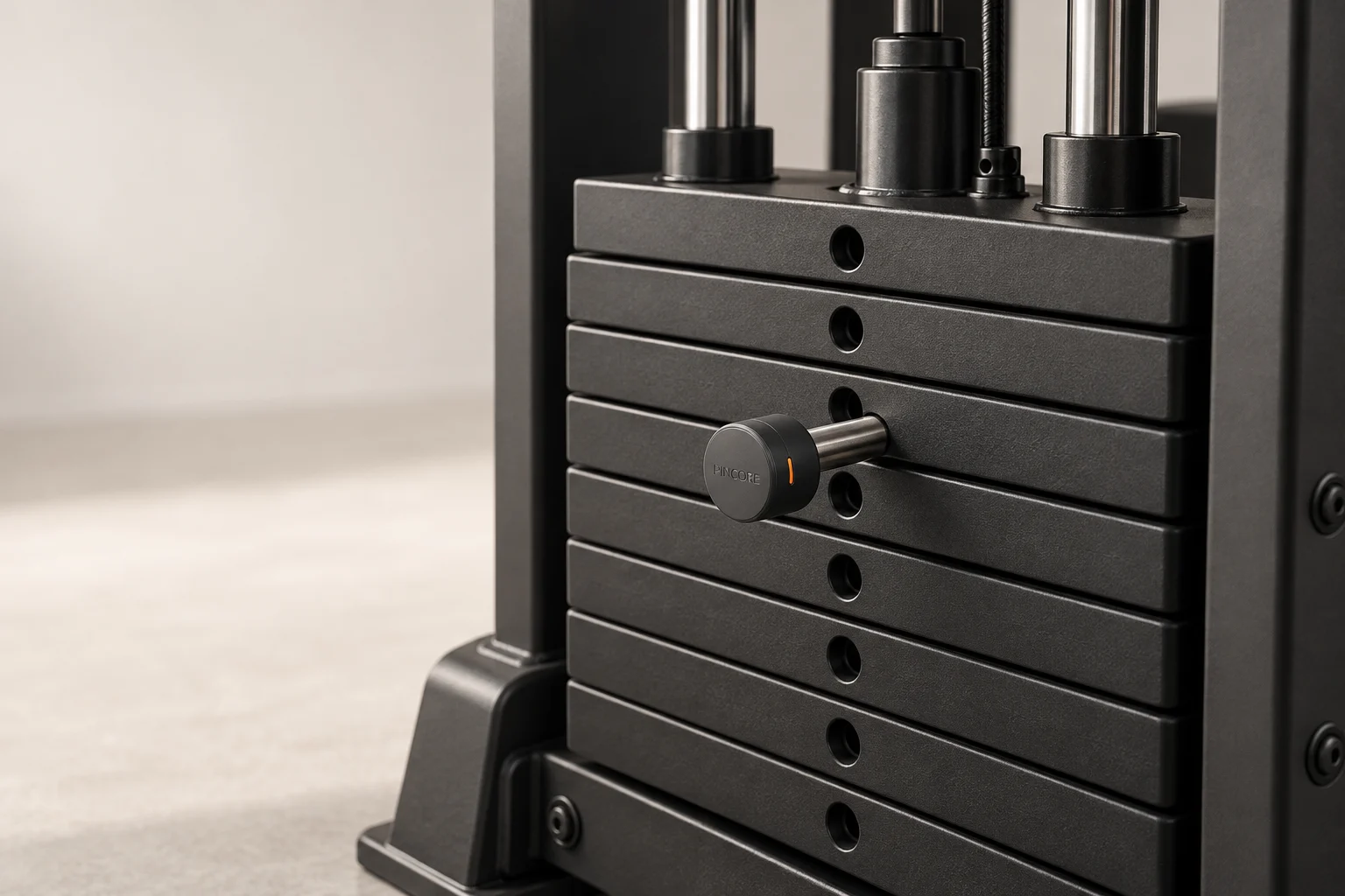 Concept visualization: compact graphite PINCORE cap on the existing selector pin of a weight stack